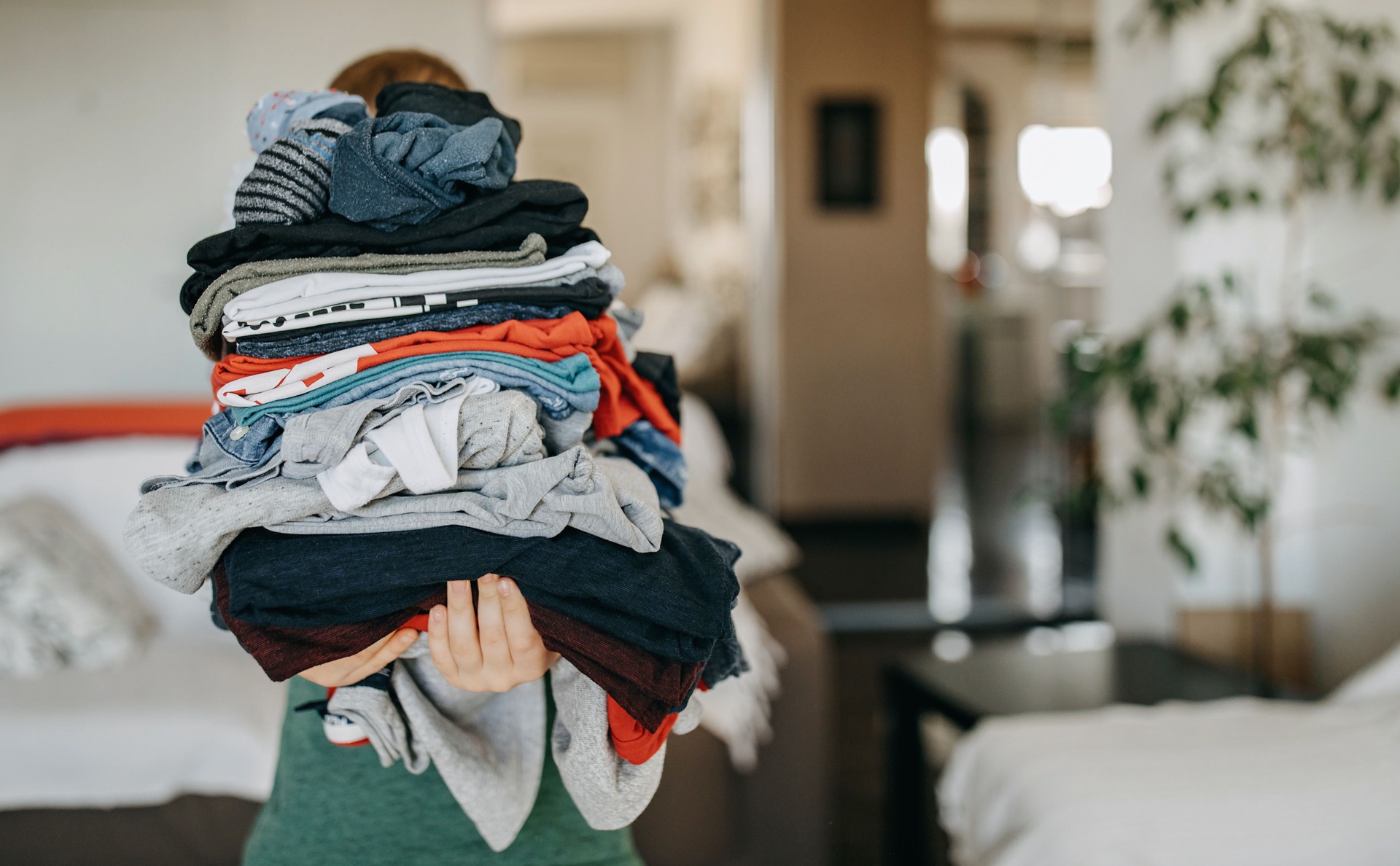 Young boy folds clothes